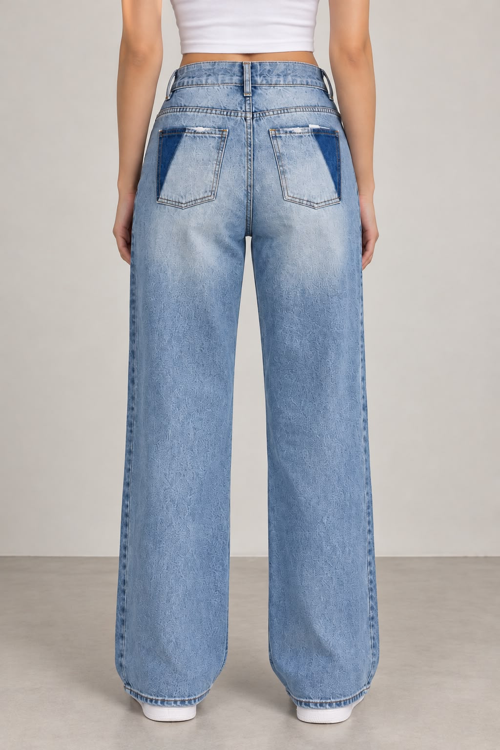 Wide-leg jeans featuring front distressing and distinctive back pockets.