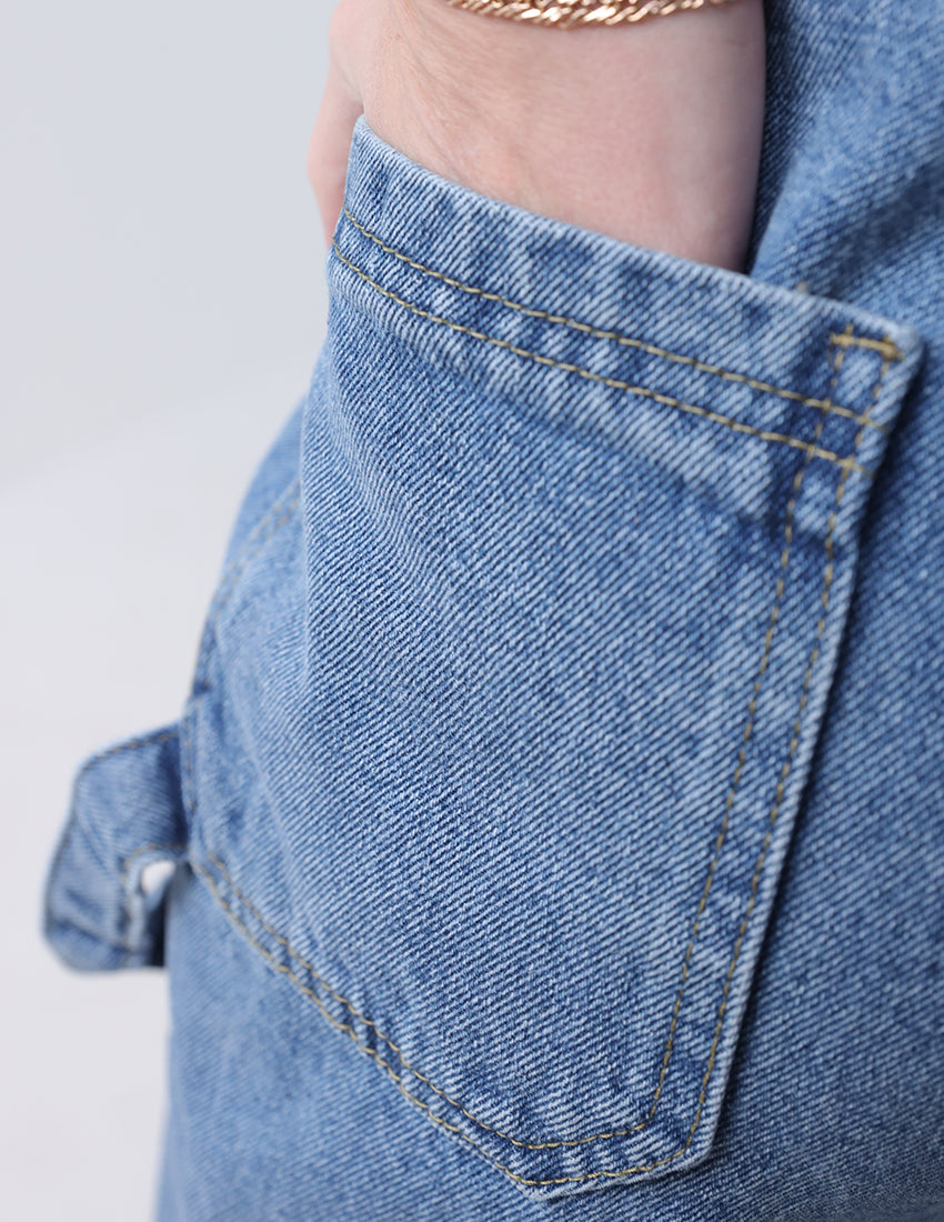 High-waisted baggy blue jeans with side embellishments