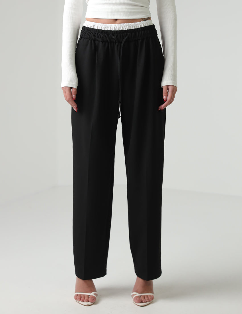 Black straight-cut pants with a white elastic waistband