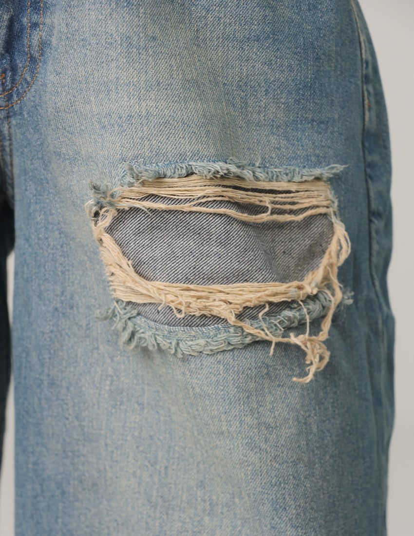 بنطال جينز أزرق ممزق واسع الساقين