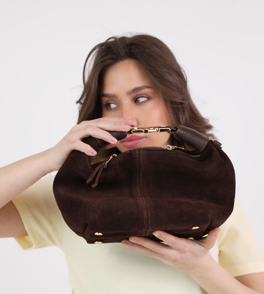 Small suede handbag with a gold buckle
