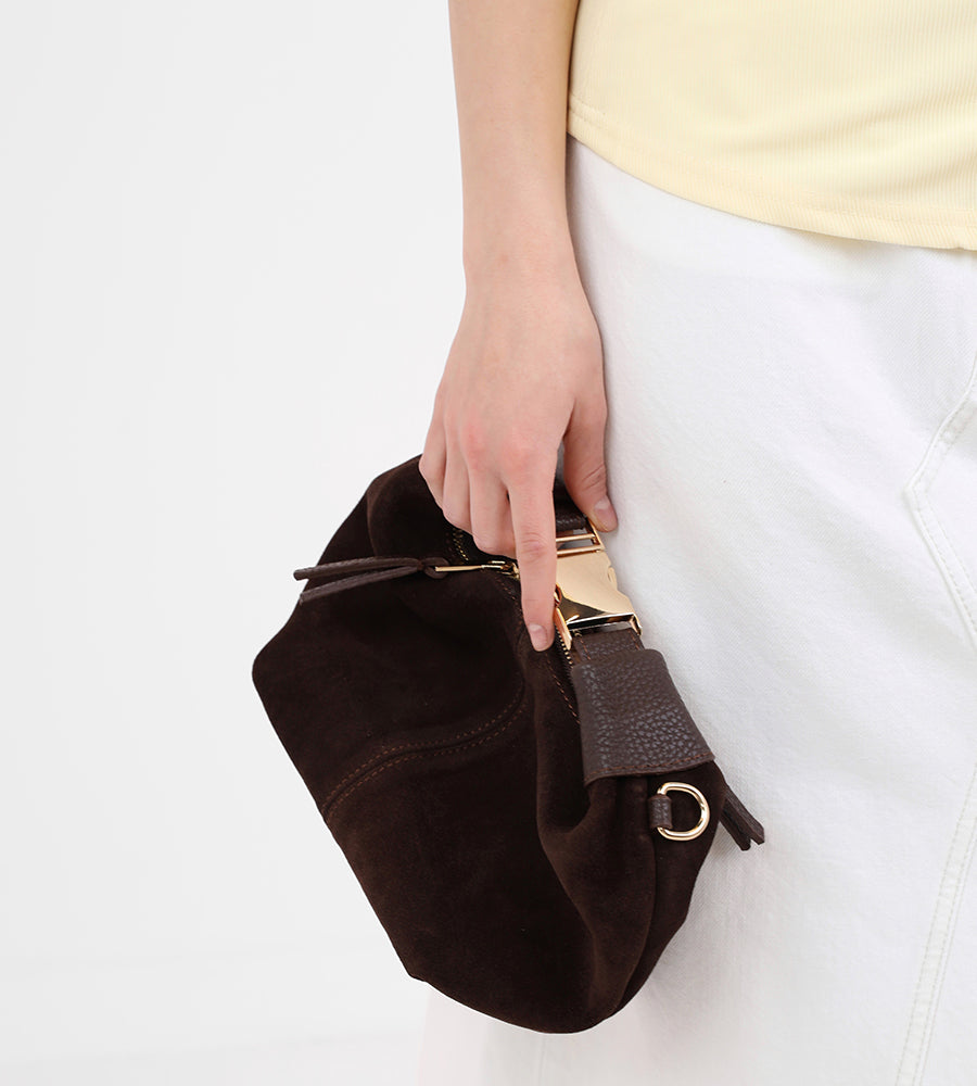 Small suede handbag with a gold buckle