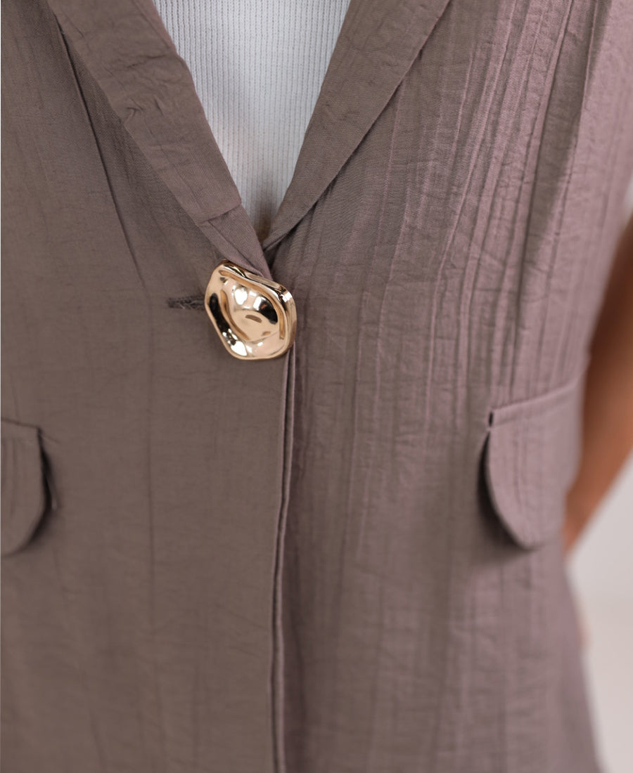Long vest with golden button