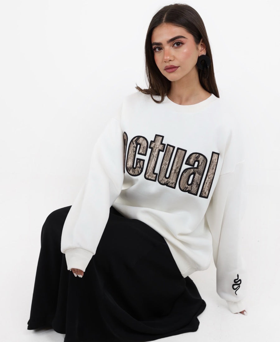 Oversized white sweater with a snakeskin print.