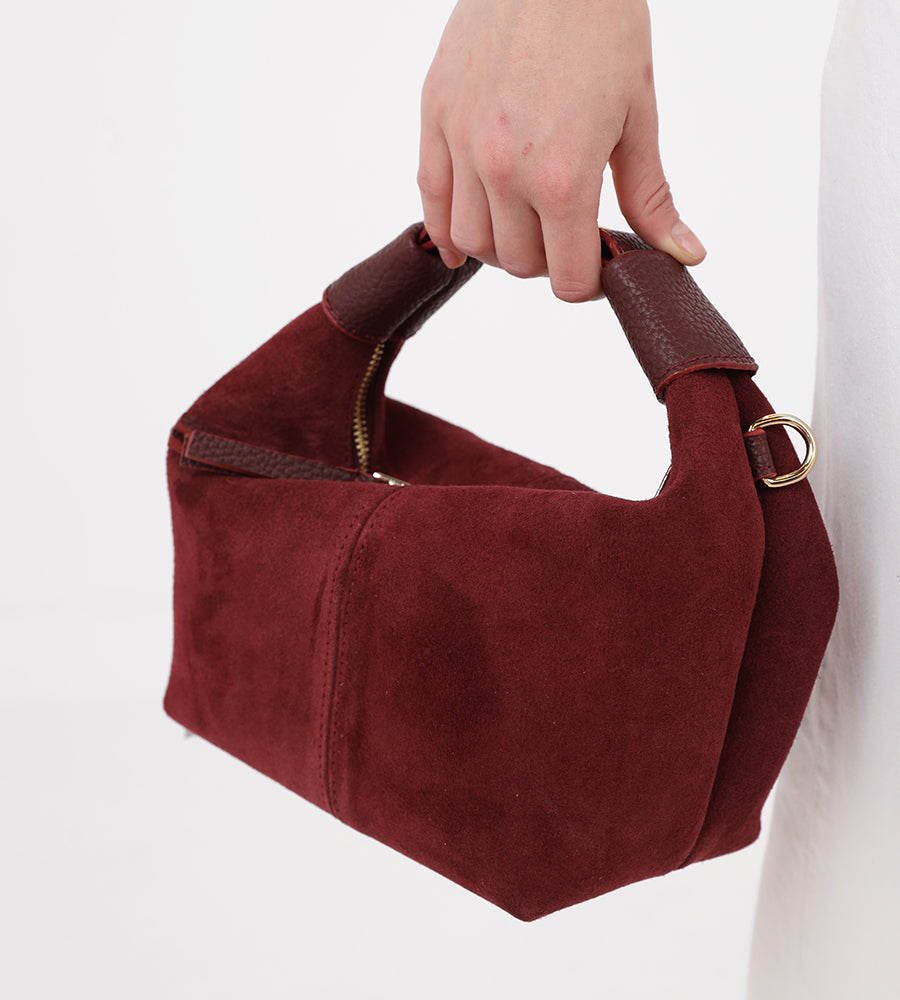 Small suede handbag with a gold buckle