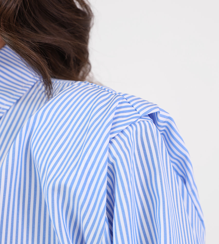Striped shirt with sun brooch