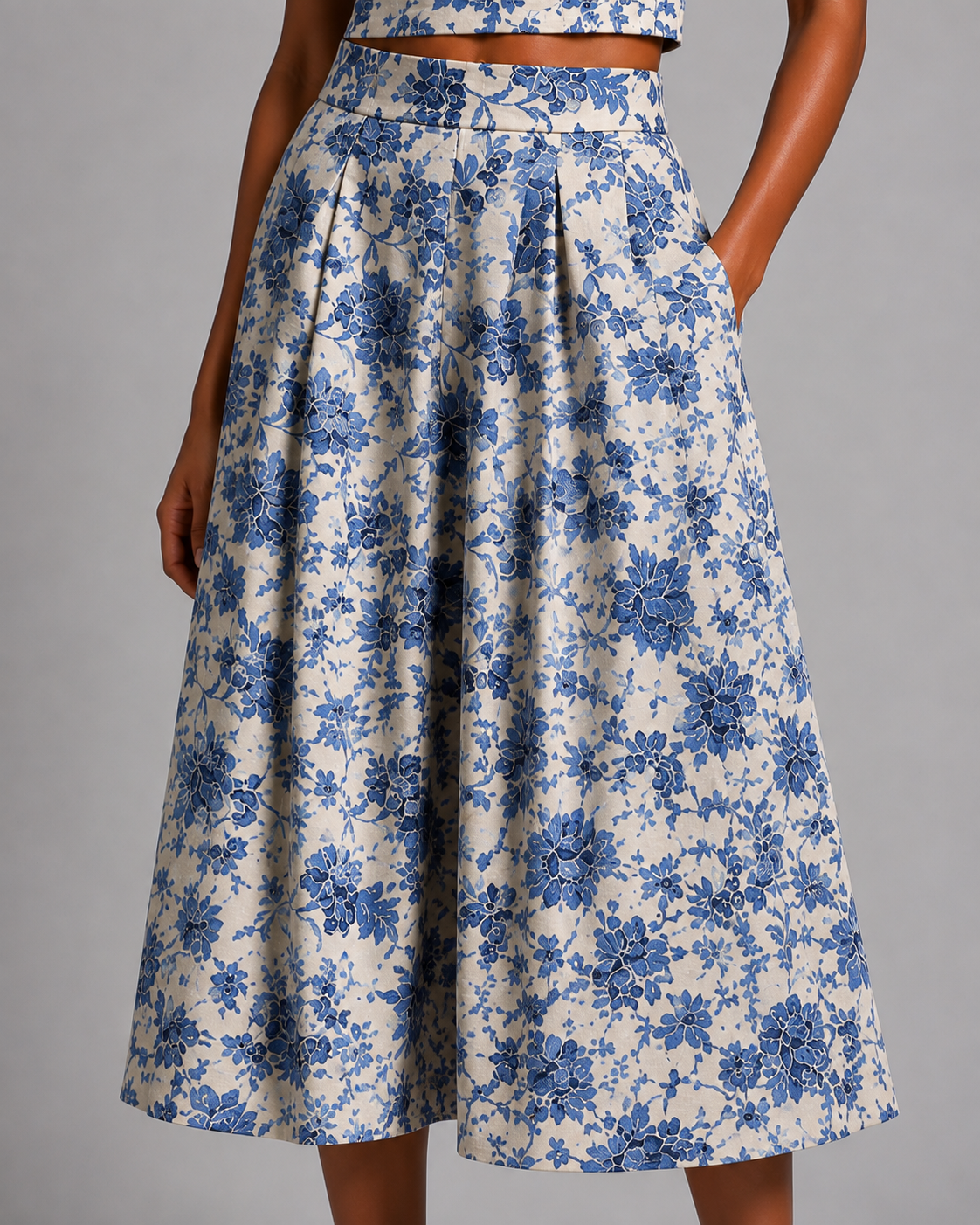 Blue floral set featuring a sleeveless crop top and a midi skirt.