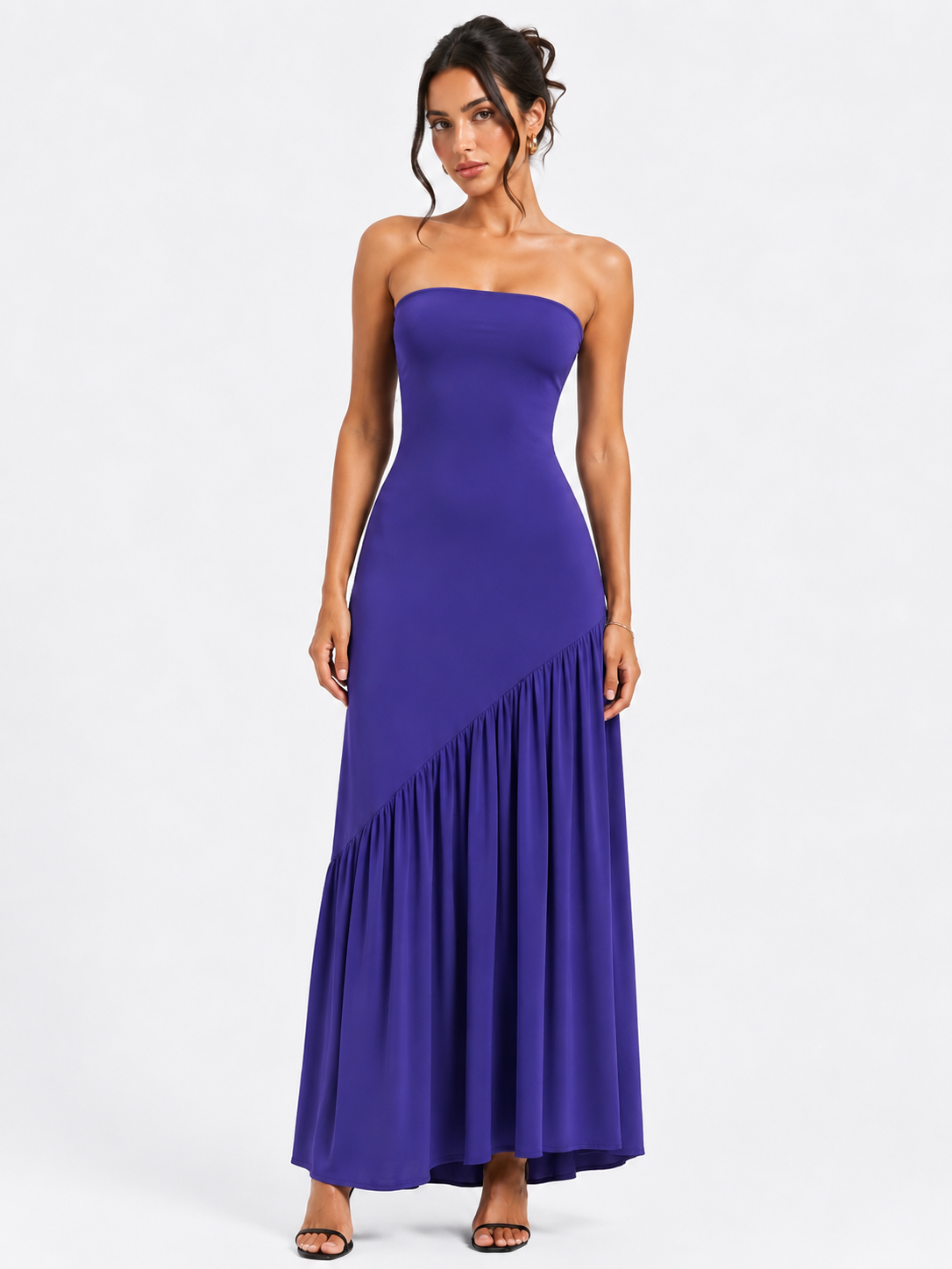 A long, backless dress featuring an asymmetrical waist, a front slit,