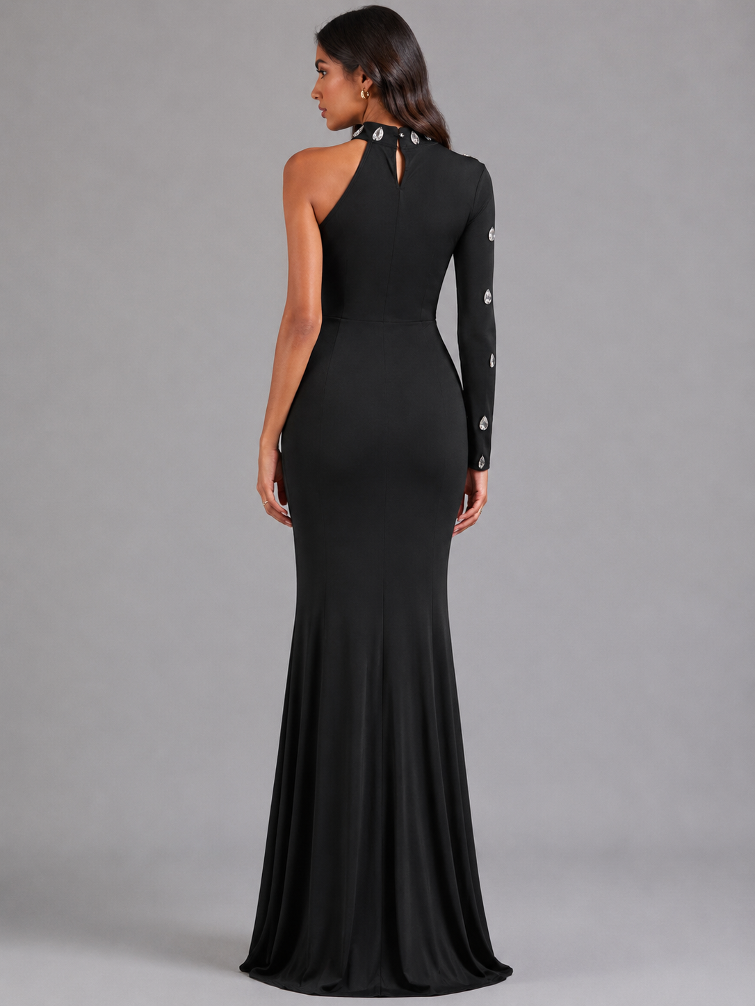 Long black one-shoulder dress with crystals.