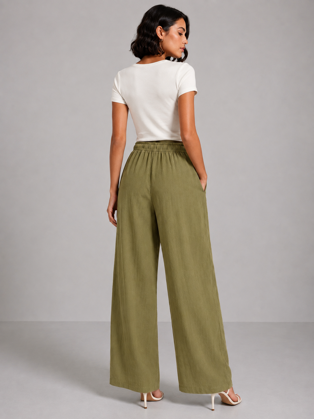 Olive green linen trousers with embroidery on both sides.