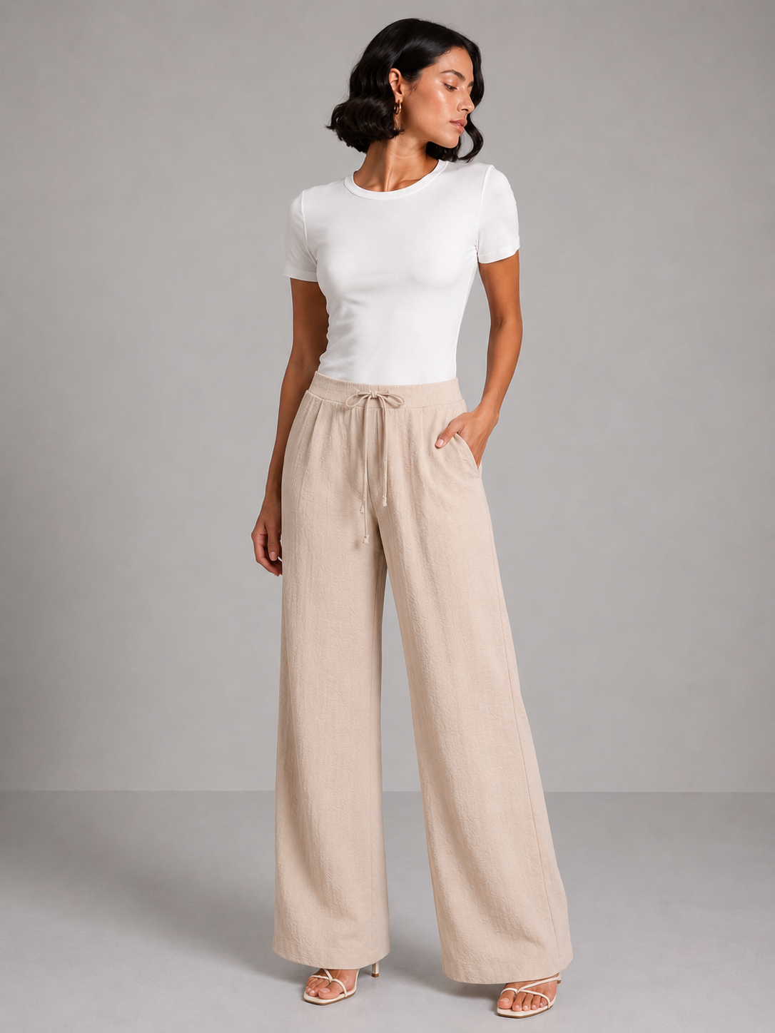 Wide-leg trousers with a tie waist and pleats.