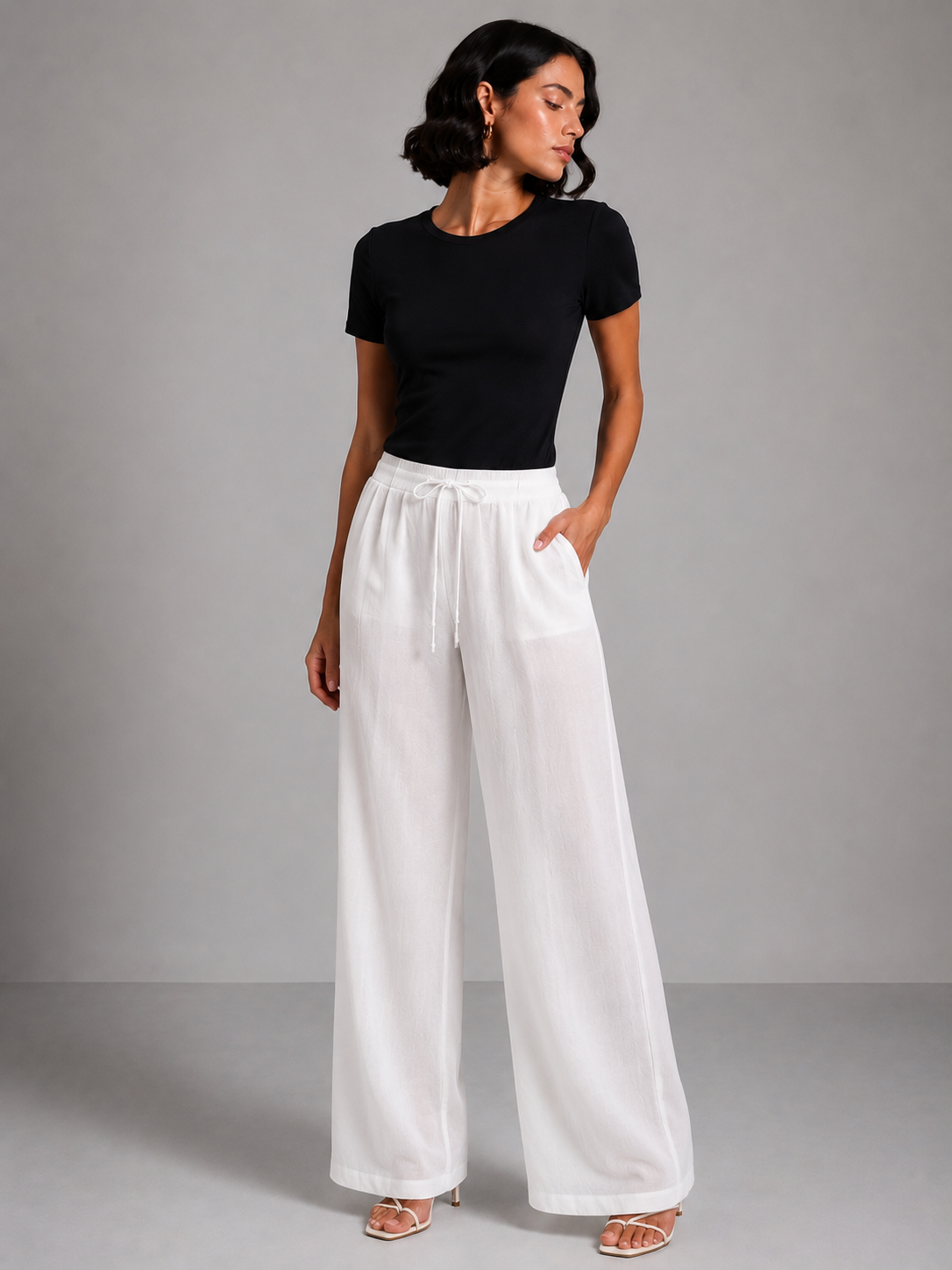 Wide-leg trousers with a tie waist and pleats.