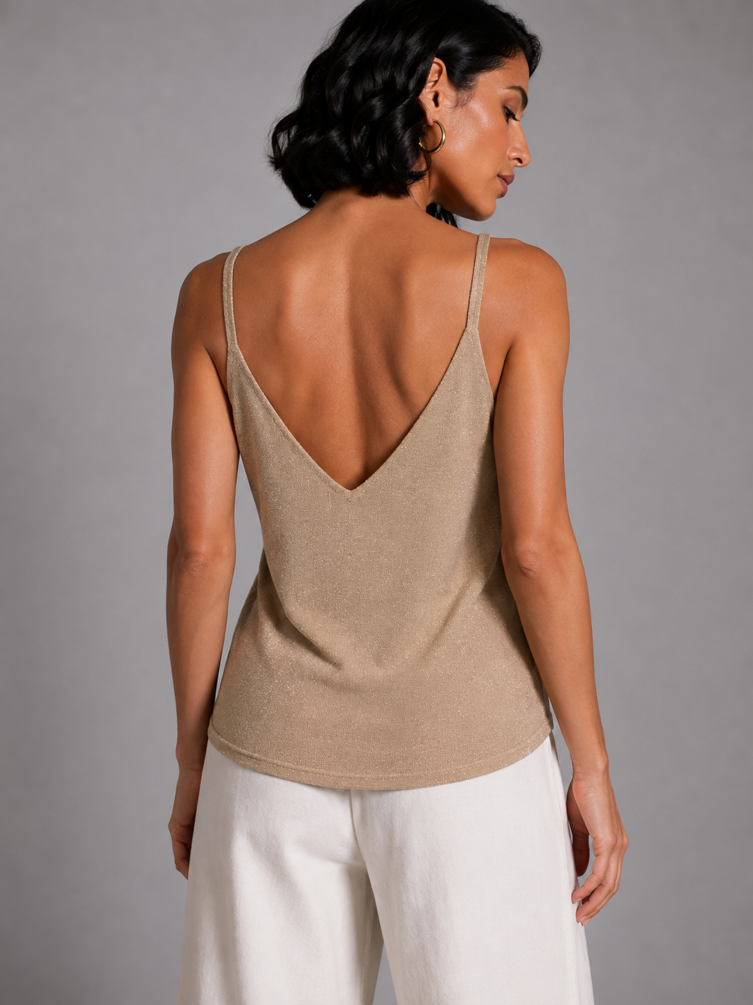 Beige shimmering sleeveless V-neck top with lace detail.