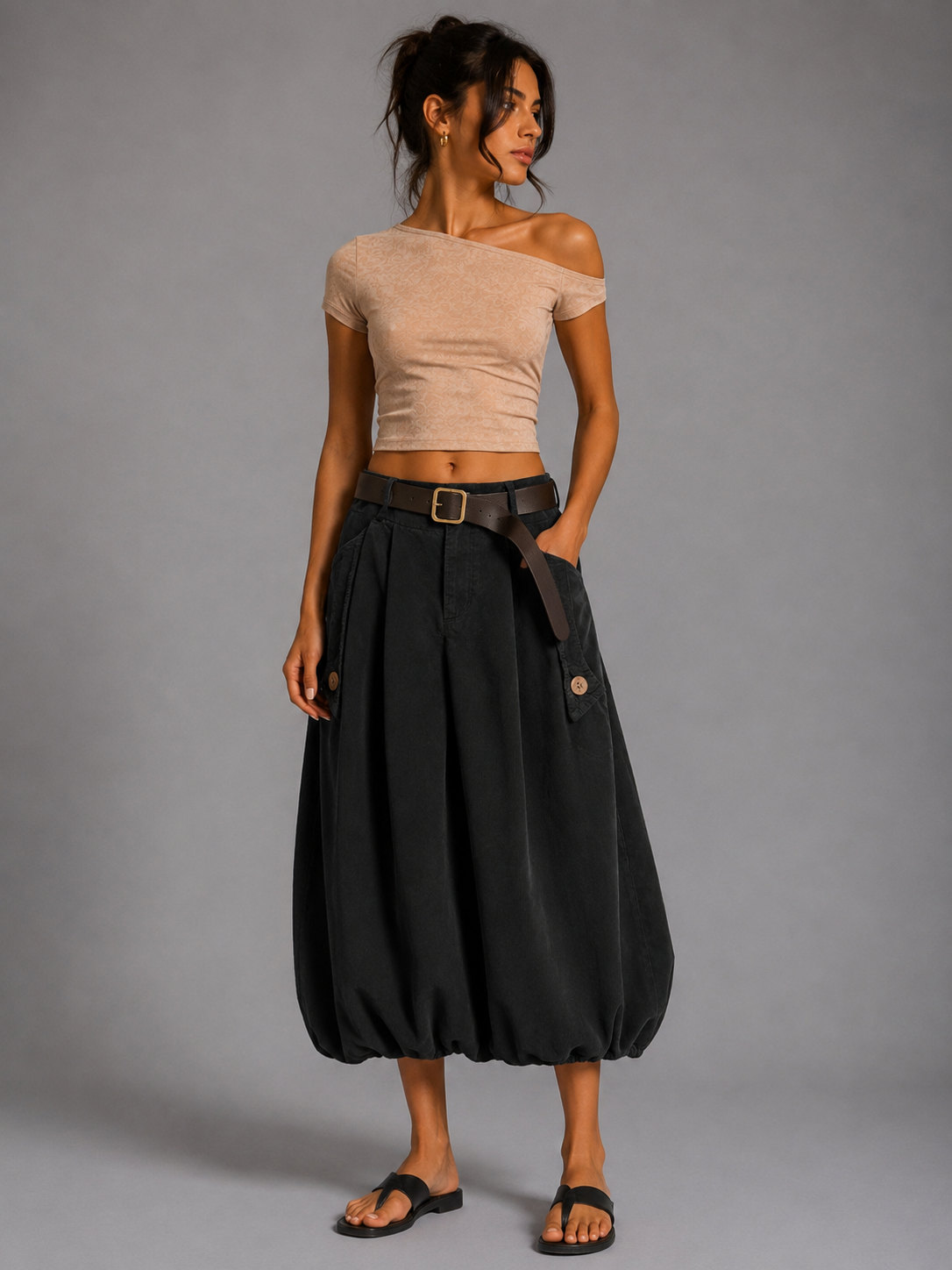 Long black corduroy skirt with a brown belt.