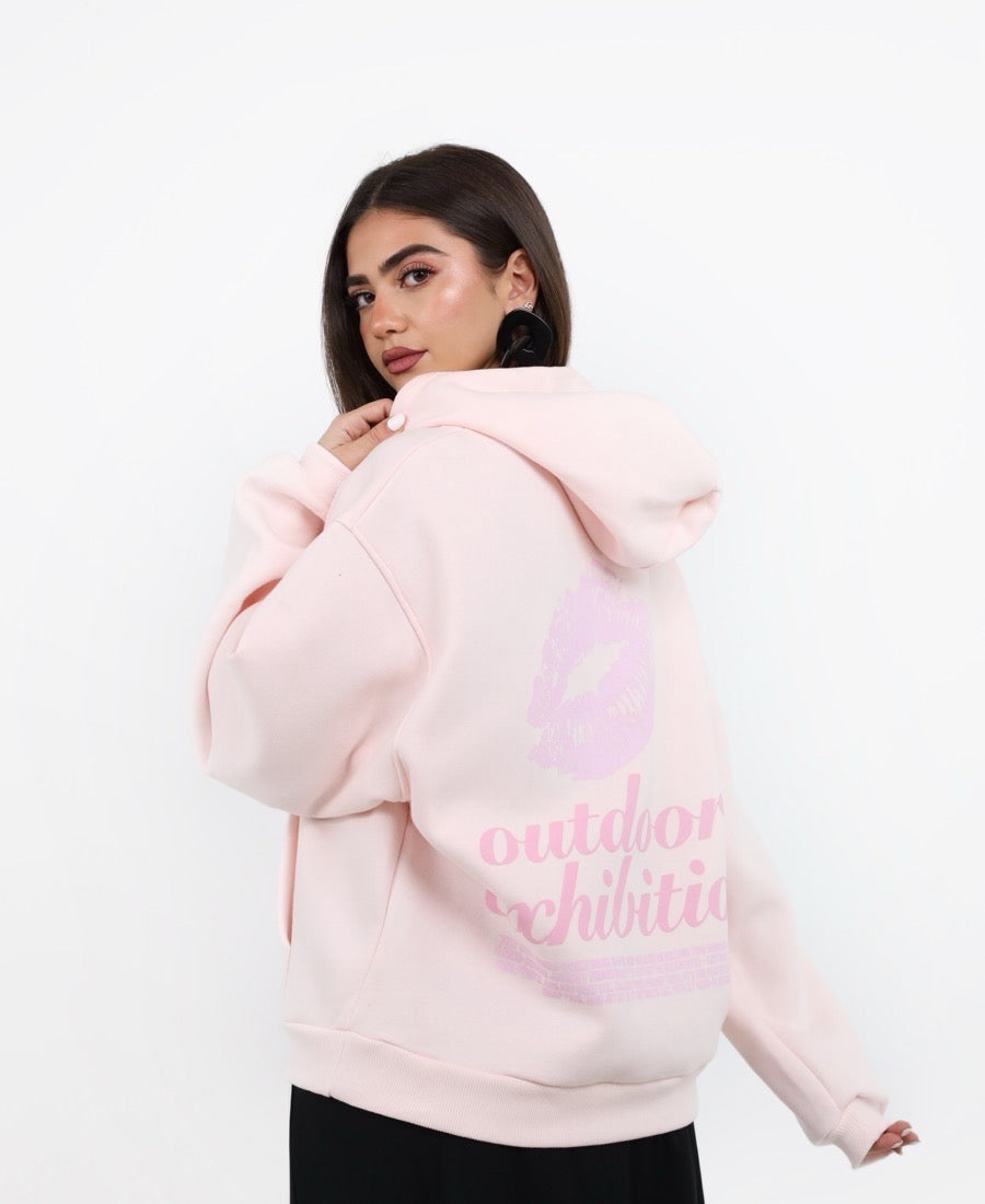 Strawberry hoodie with a kiss-themed message.