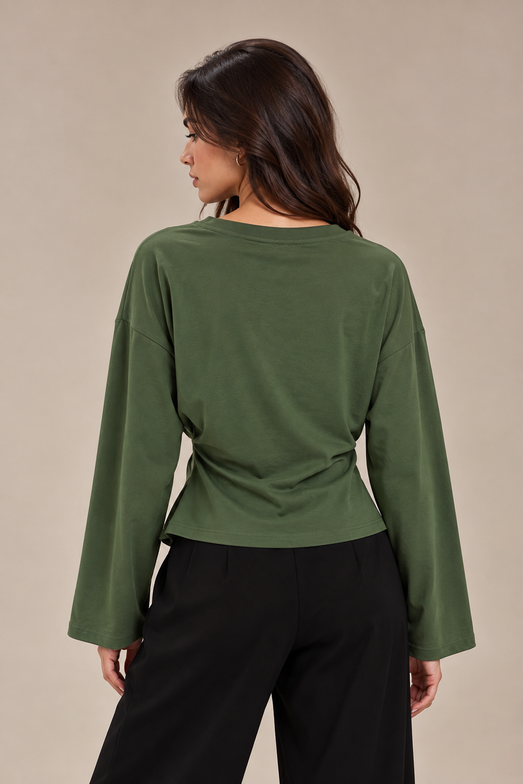 A blouse with wide sleeves and a gathered waist at the side.