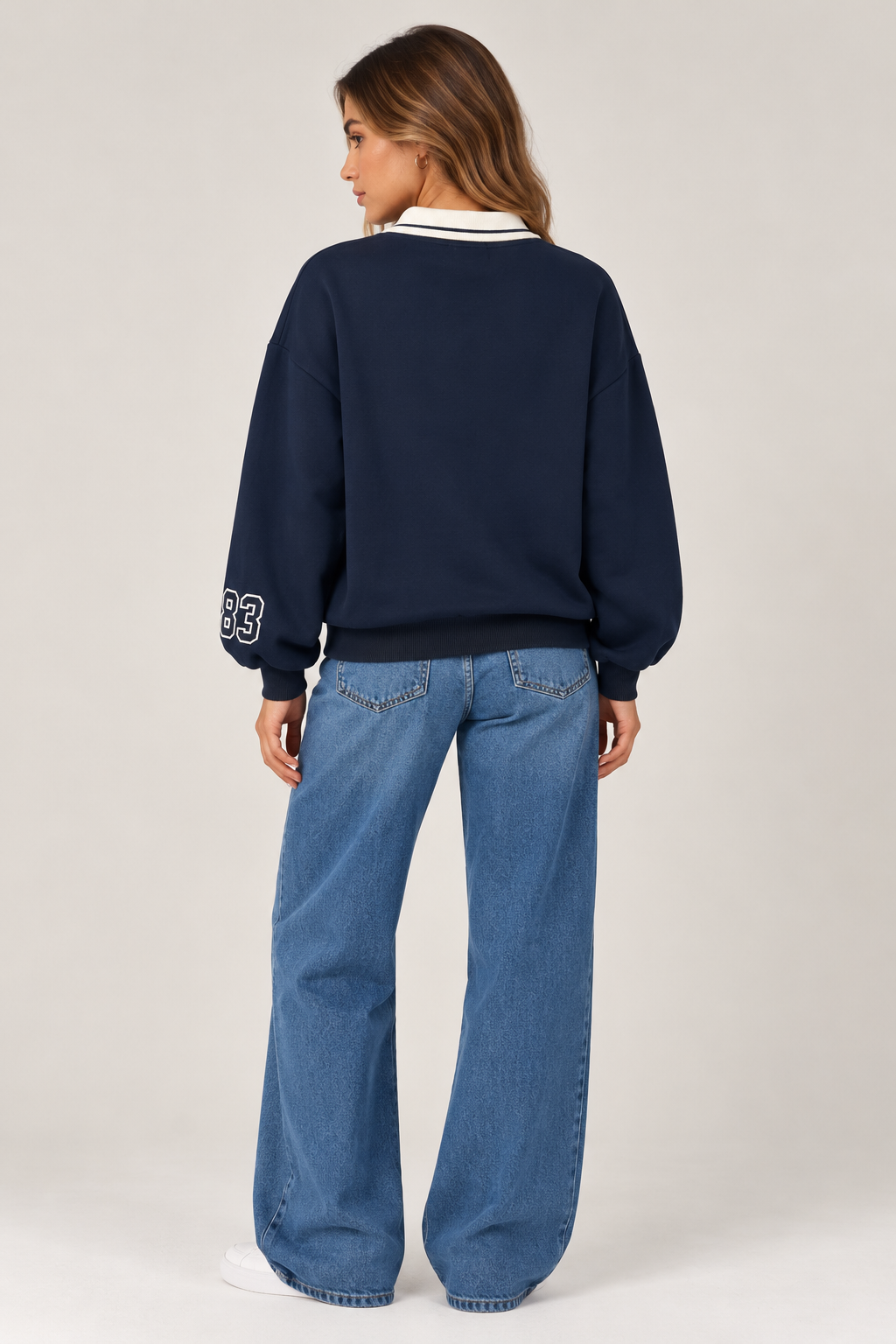 Oversized navy blue blouse with a white shirt collar. "Artistic DEPARTMENT" written on the chest in white, and "83" on the sleeve.