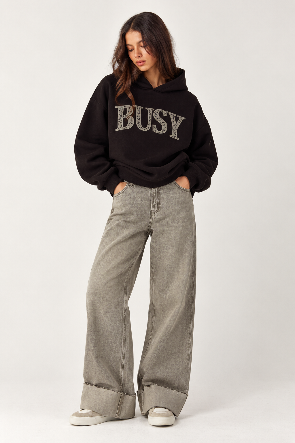 Oversized brown hoodie with a hood and the word "BUSY" written on the chest in tiger print, plus a pocket.