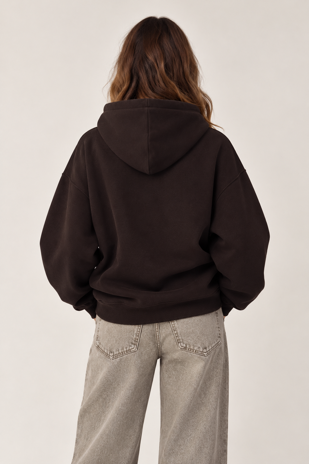Oversized brown hoodie with a hood and the word "BUSY" written on the chest in tiger print, plus a pocket.