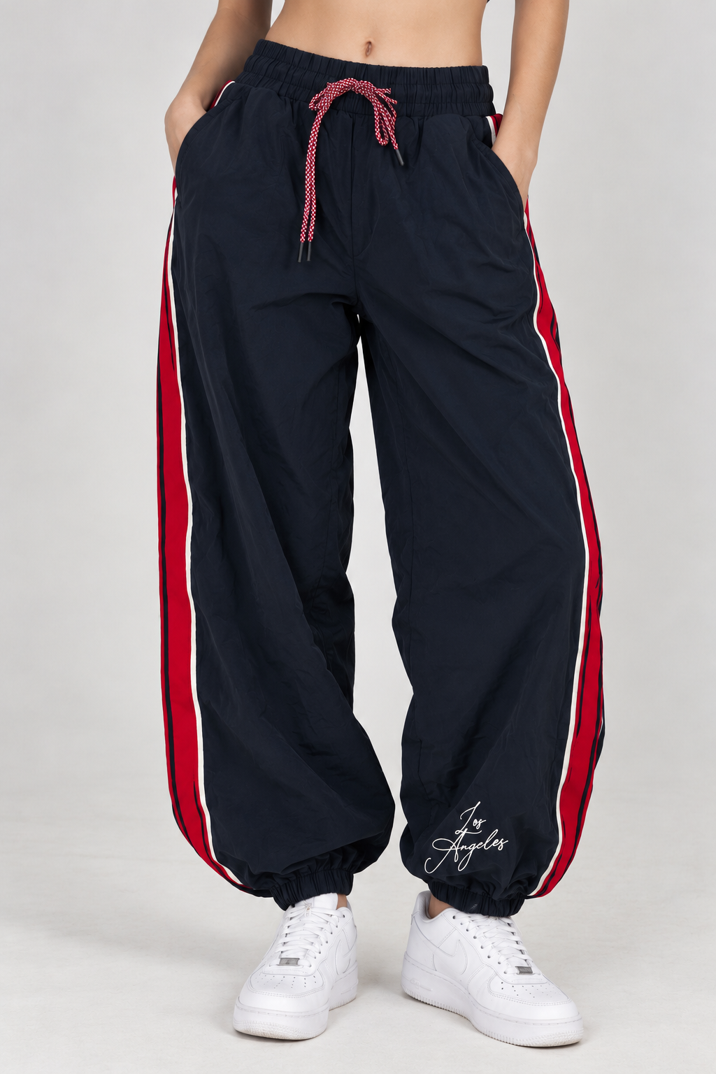 Navy blue waterproof pants with a red line down the leg and the words "LOS ANGELES"