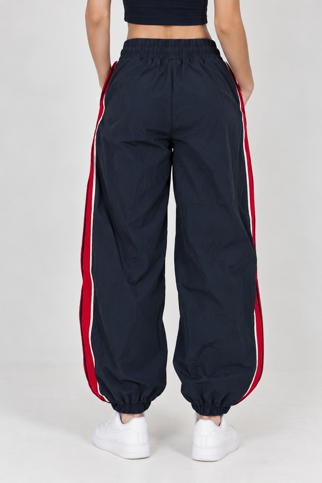 Navy blue waterproof pants with a red line down the leg and the words "LOS ANGELES"