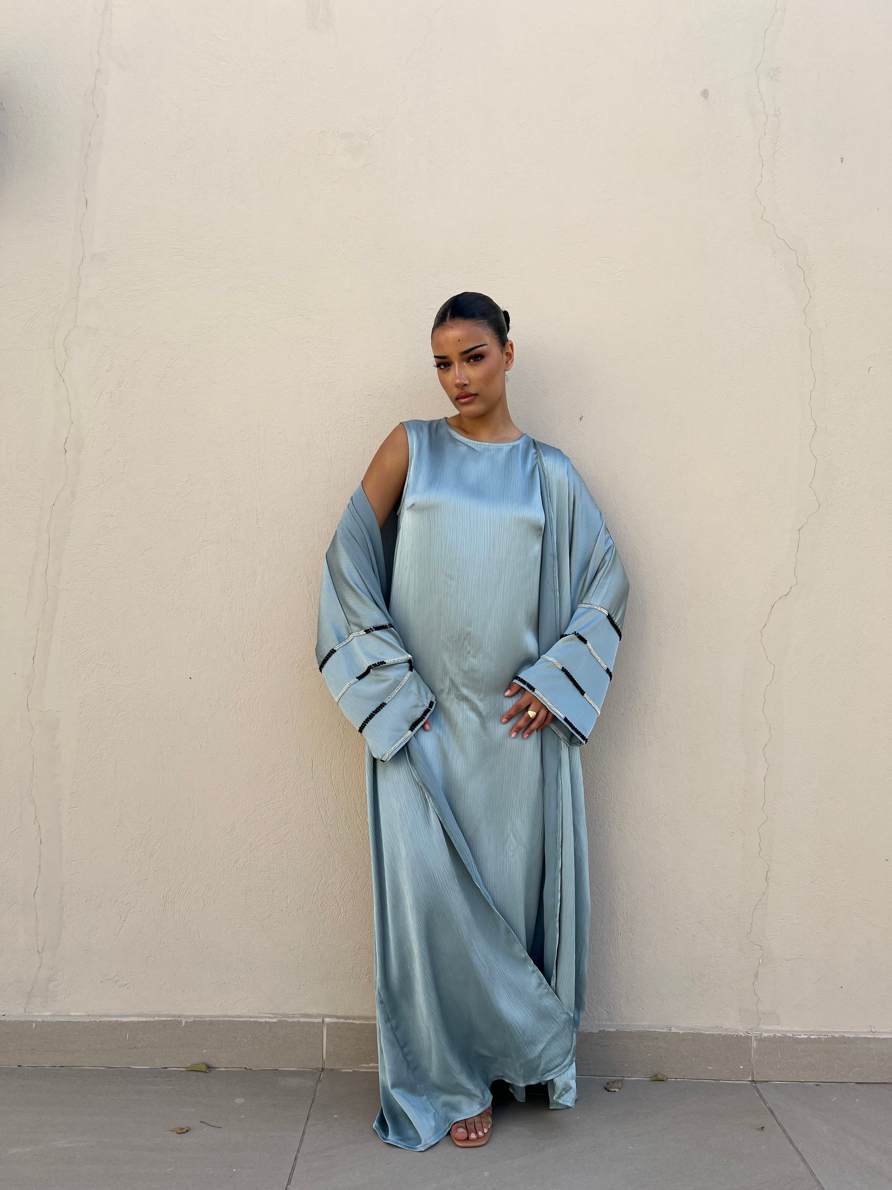 Flowy abaya with beads on the sleeves and a sleeveless dress