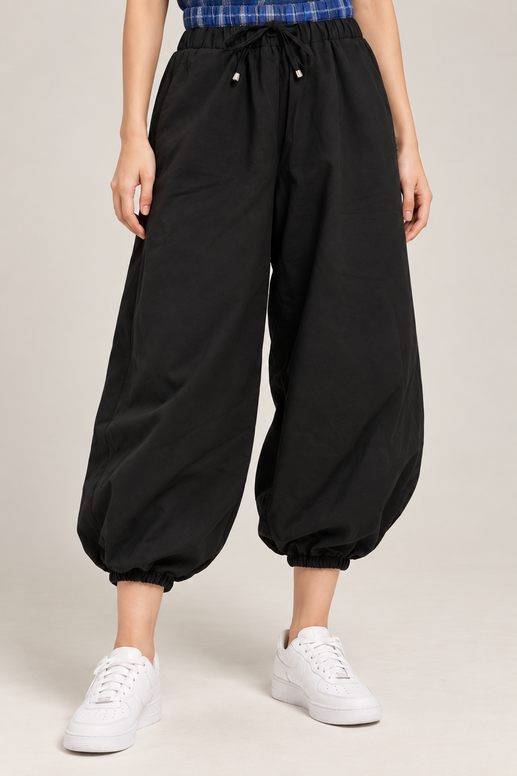 Black balloon pants with a blue checkered waistband and tie