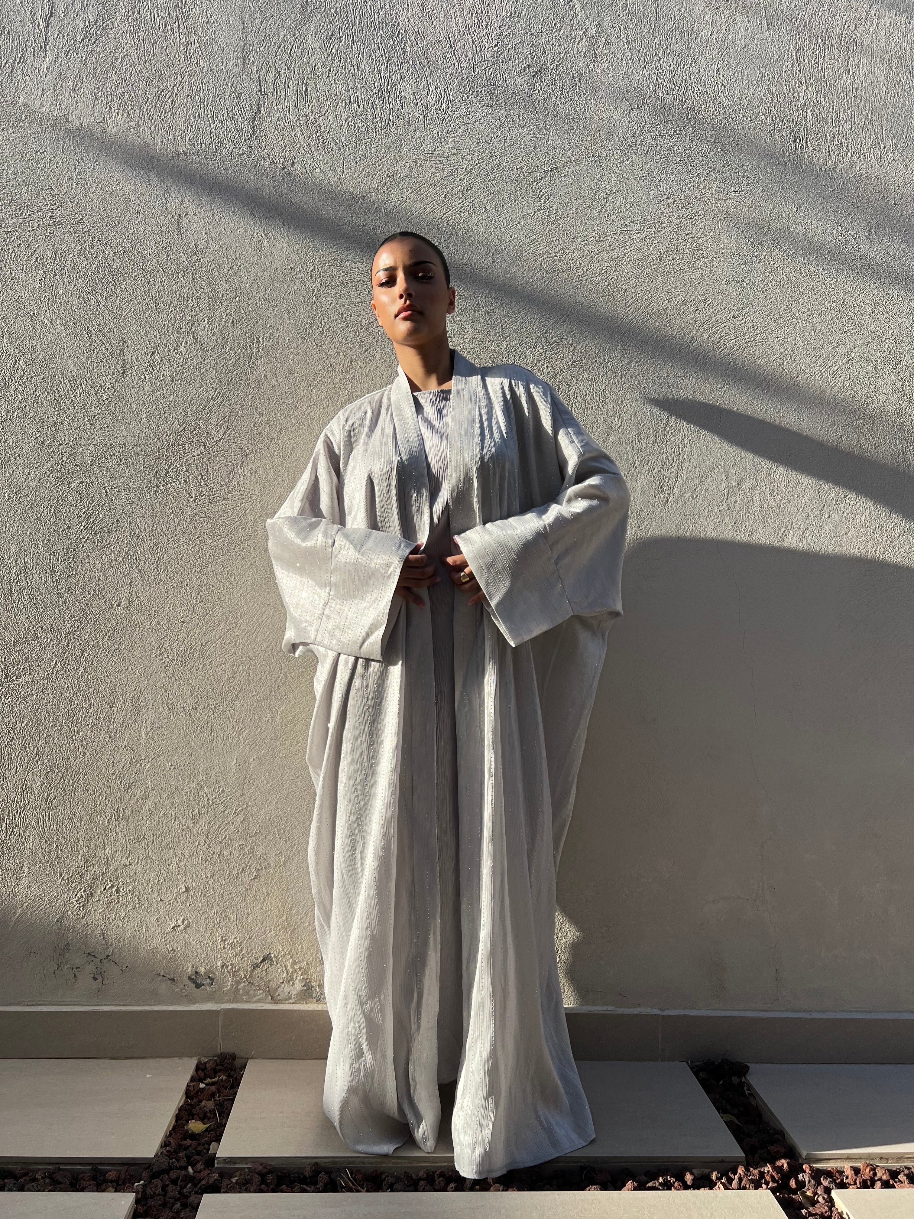 Abaya with a gray dress studded with rhinestones