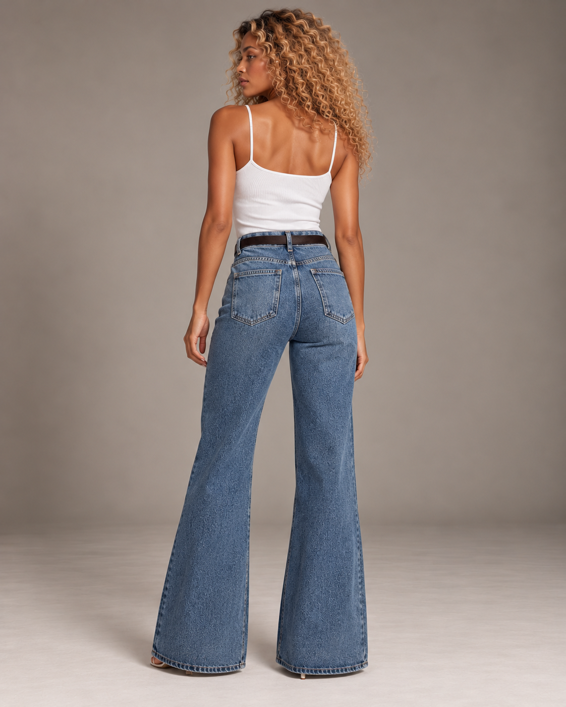 Blue flared jeans with a brown belt and a small wallet