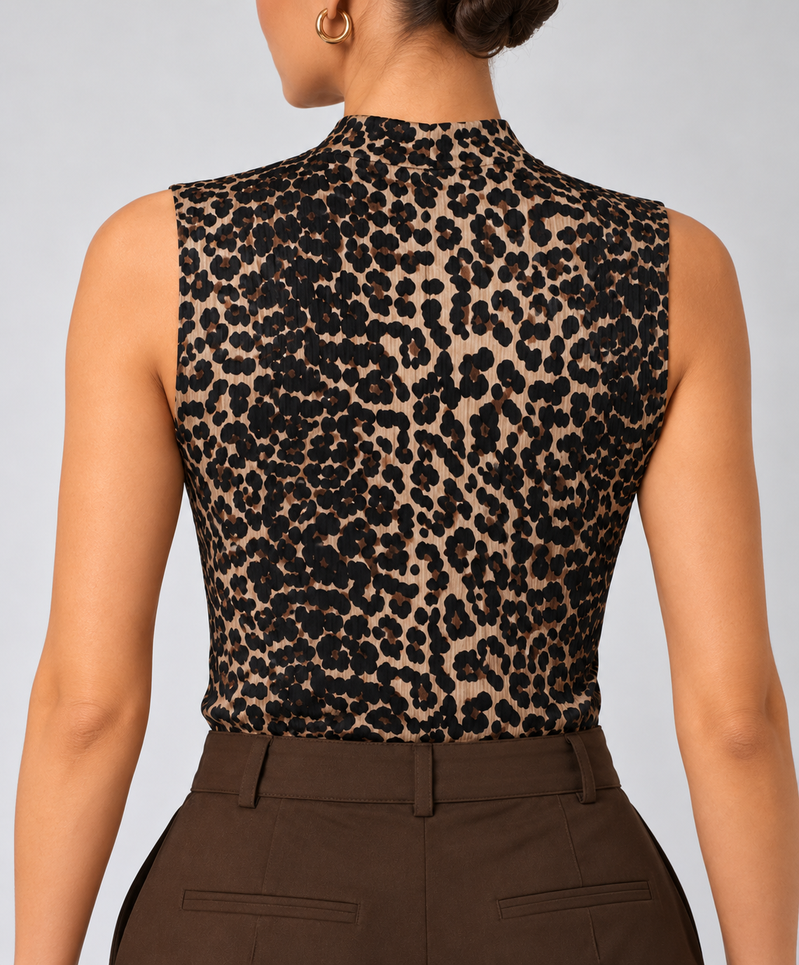 Sleeveless tiger print top with a high neck
