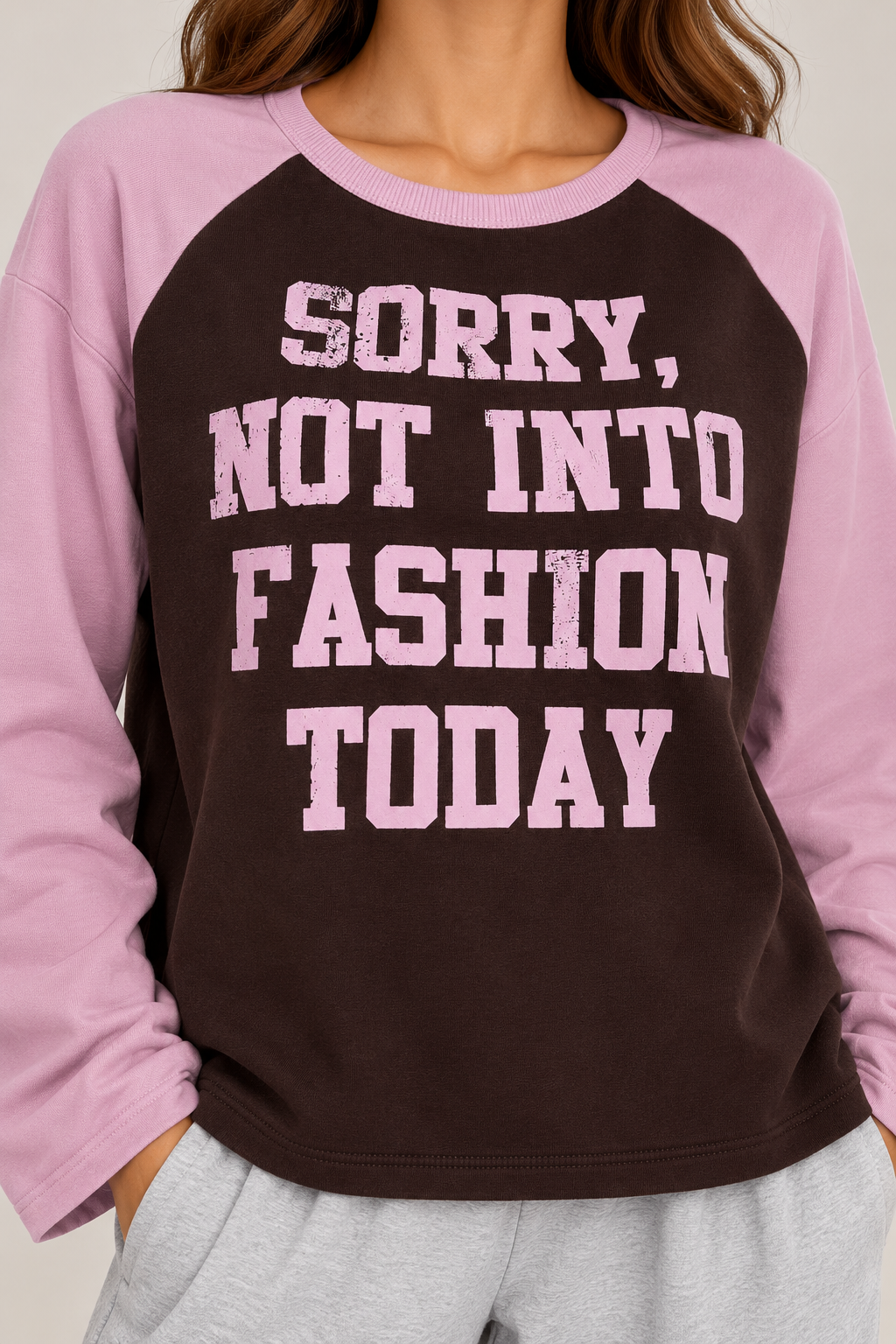 An oversized two-tone blouse featuring the words "Sorry not into fashion today"