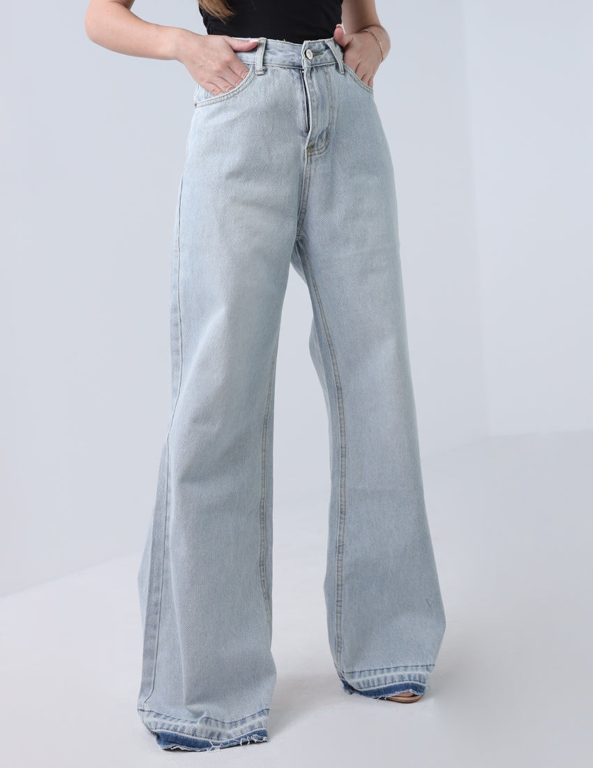 High-waisted wide leg jeans, blue with a dark blue hem.