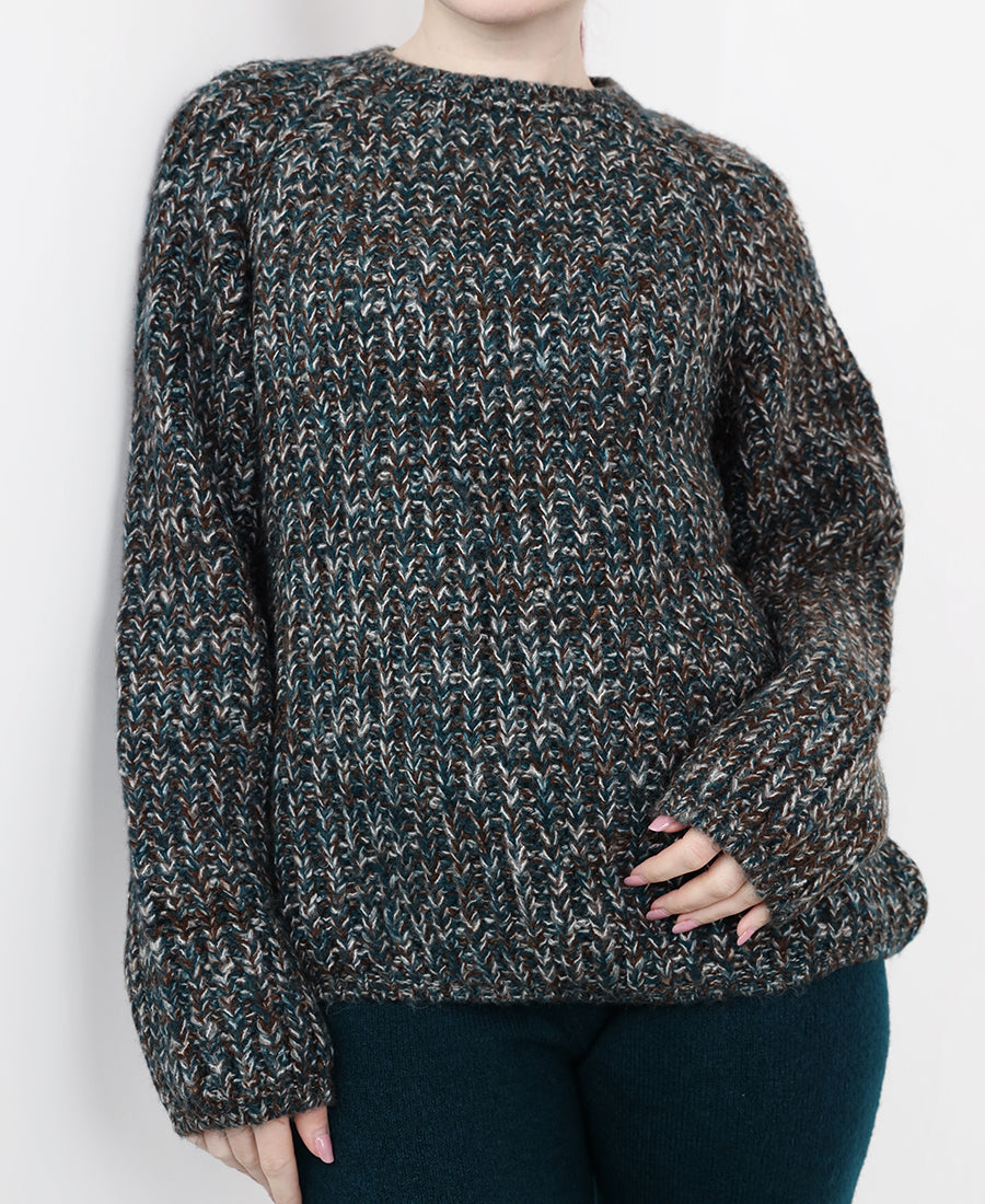 A chunky, multi-colored marl knit sweater