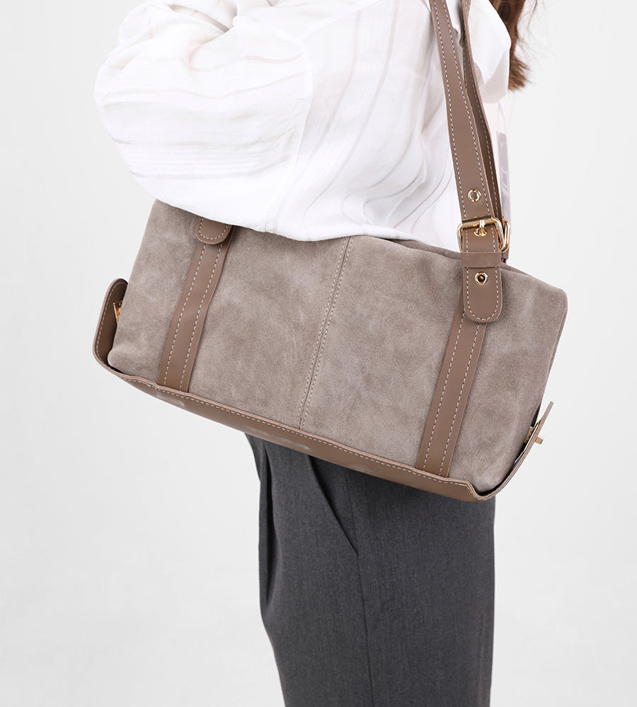 Rectangular suede handbag with a leather strap and gold accents.