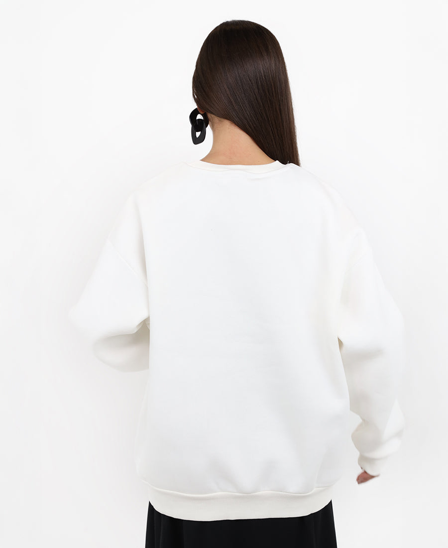 Oversized white sweater with a snakeskin print.