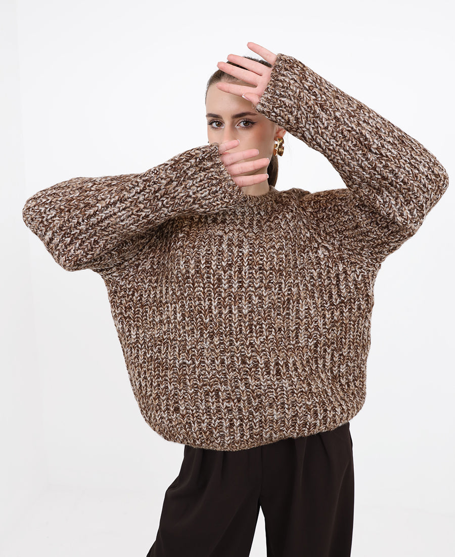 A chunky, multi-colored marl knit sweater