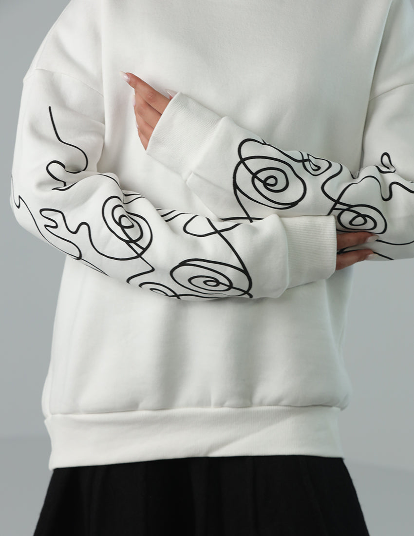 Oversized white blouse with a design on the sleeves