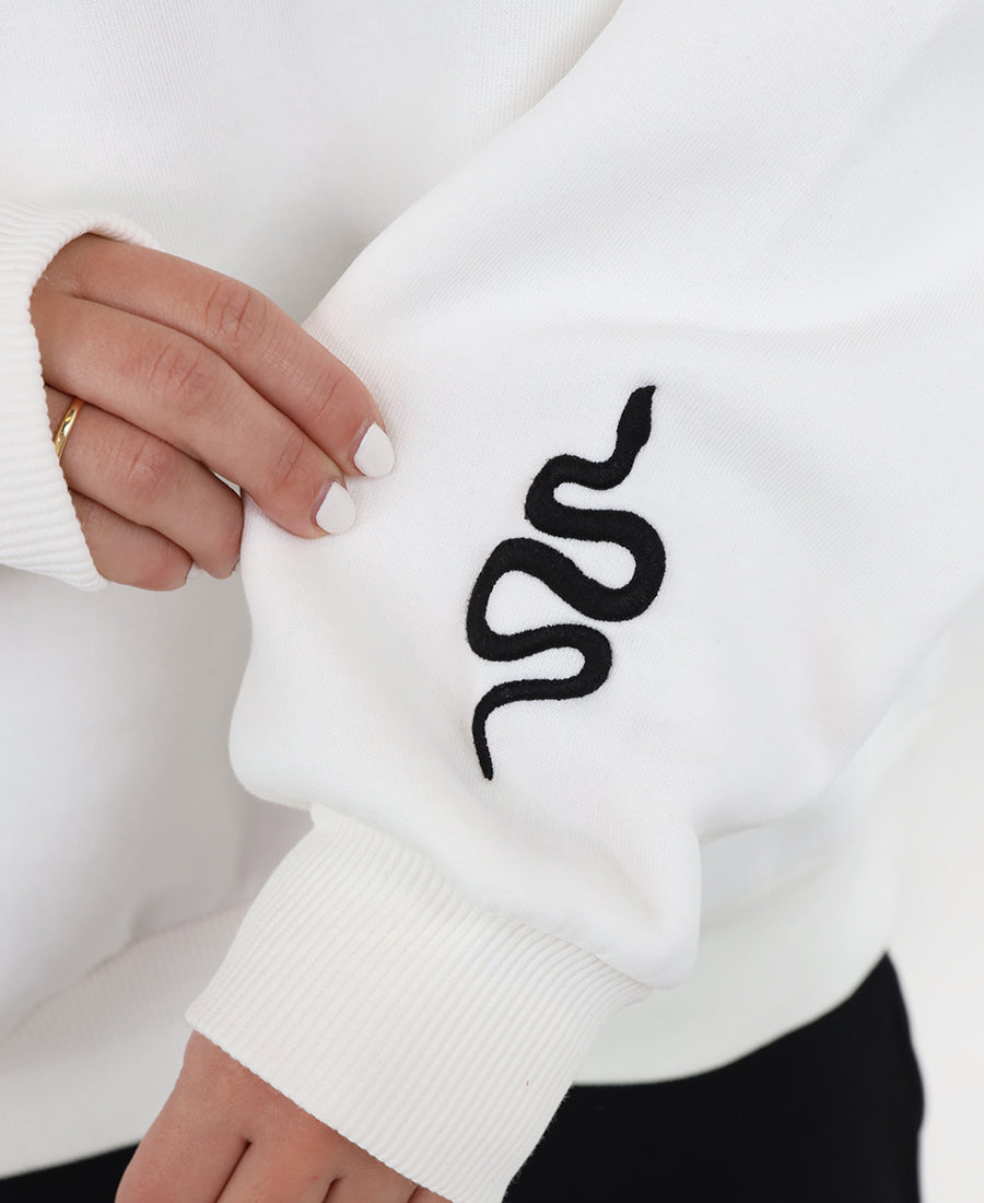 Oversized white sweater with a snakeskin print.