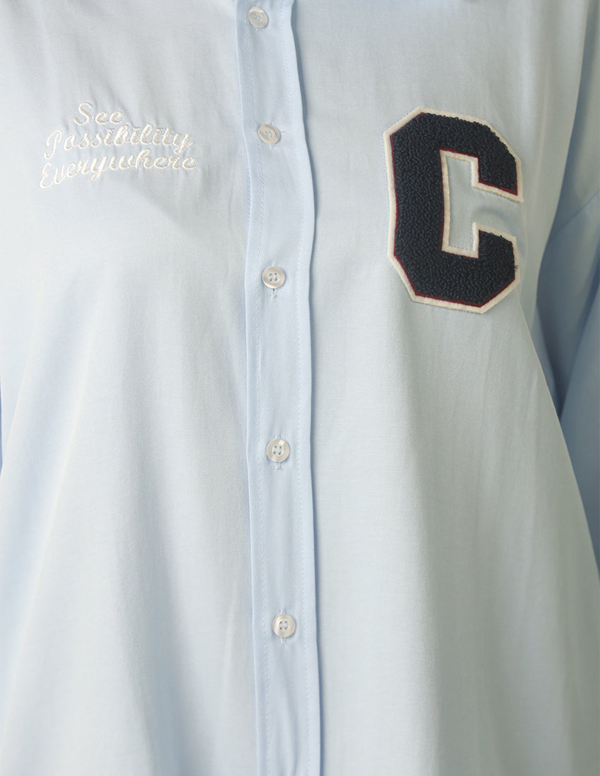 Oversized light blue shirt with the word "C" printed on it