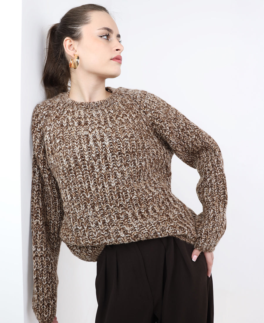 A chunky, multi-colored marl knit sweater