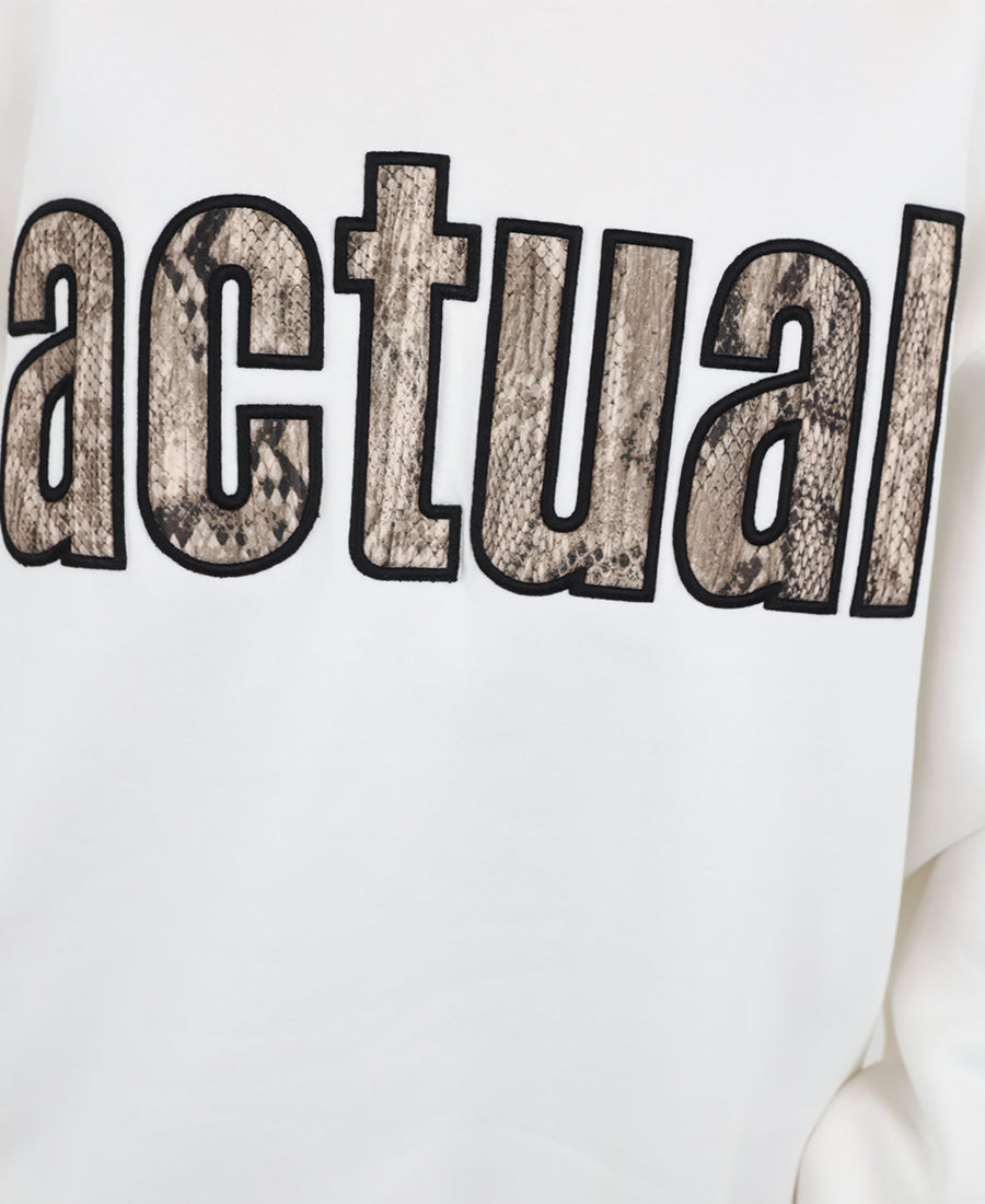 Oversized white sweater with a snakeskin print.