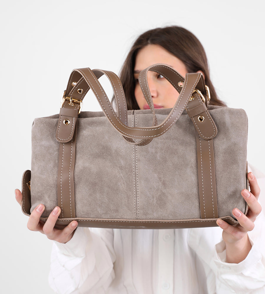 Rectangular suede handbag with a leather strap and gold accents.
