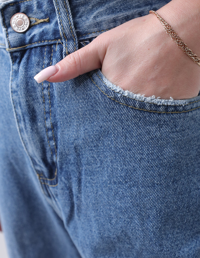 High-waisted baggy blue jeans with side embellishments