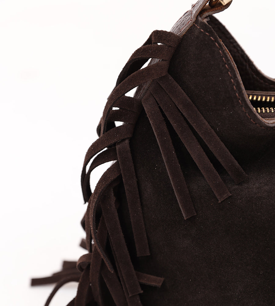 Suede bag with fringed edges and a gold handle