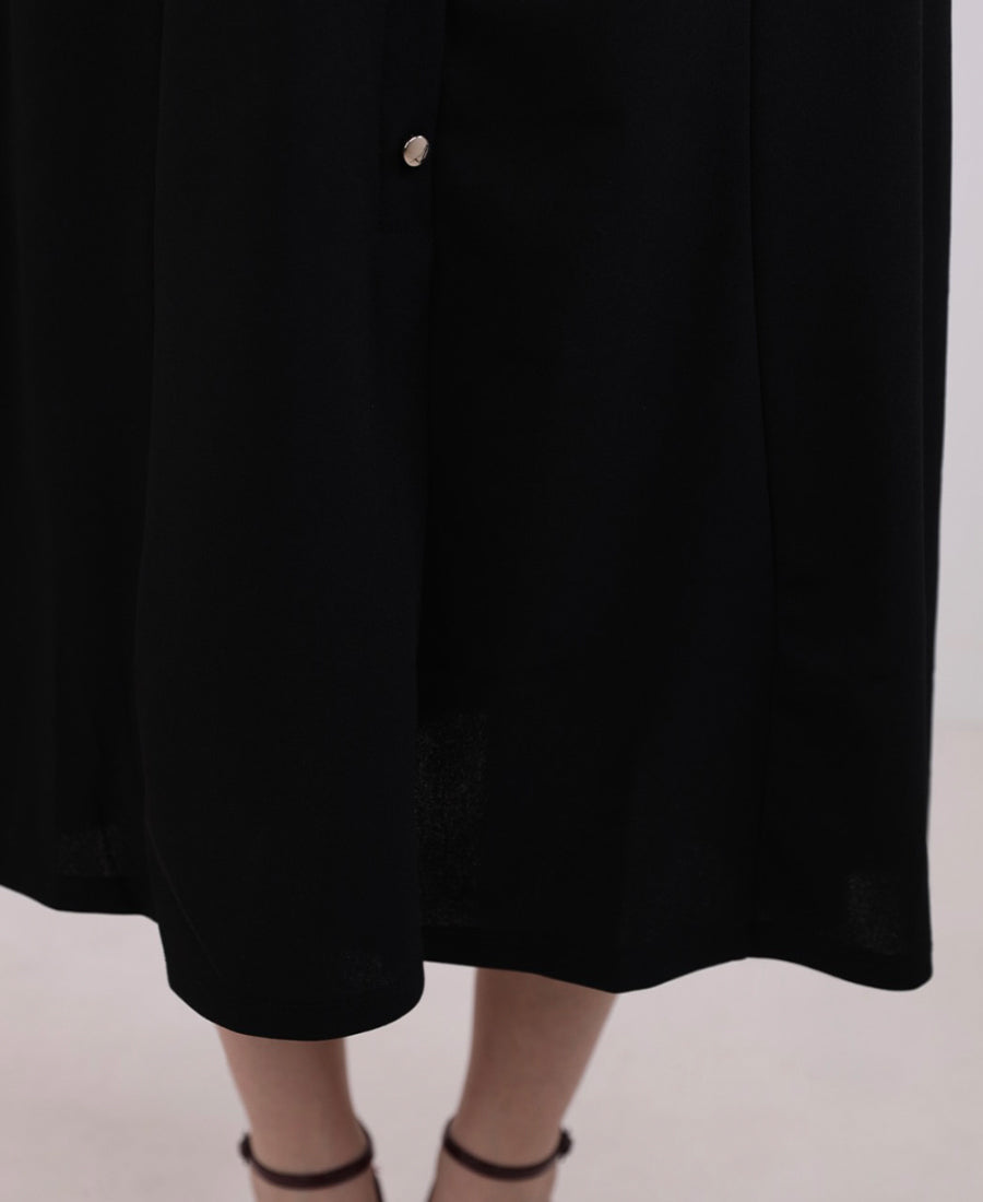 Long black dress with buttons and a gold belt