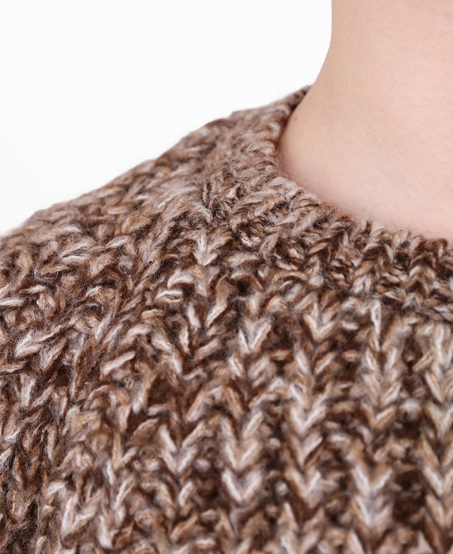 A chunky, multi-colored marl knit sweater