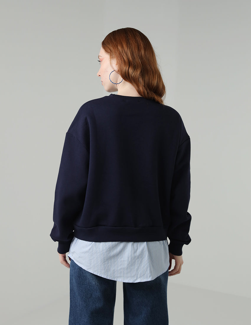 Navy blue blouse with the word "Paris" printed on it, worn with a shirt underneath.