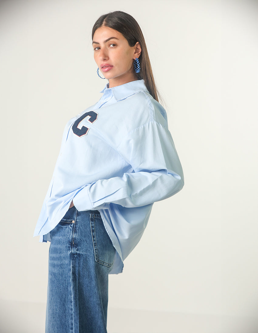 Oversized light blue shirt with the word "C" printed on it