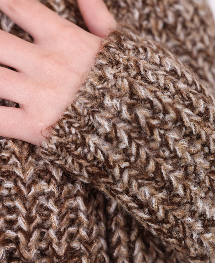 A chunky, multi-colored marl knit sweater