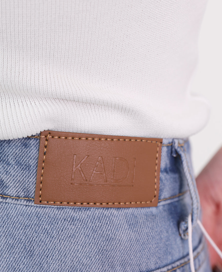 Straight-leg jeans with a slanted waist and button.